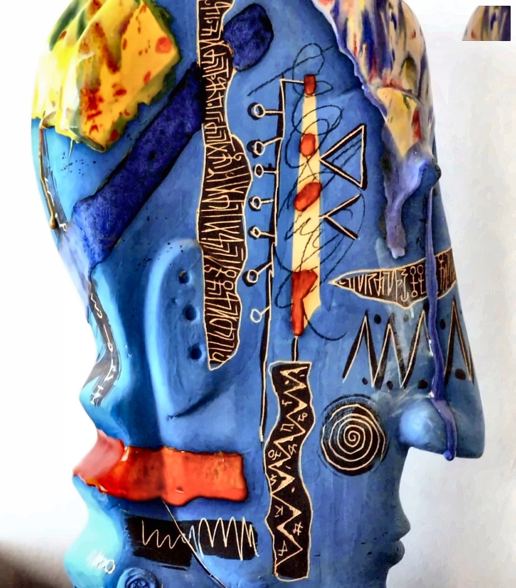 Head. Glazed ceramic with incised script.