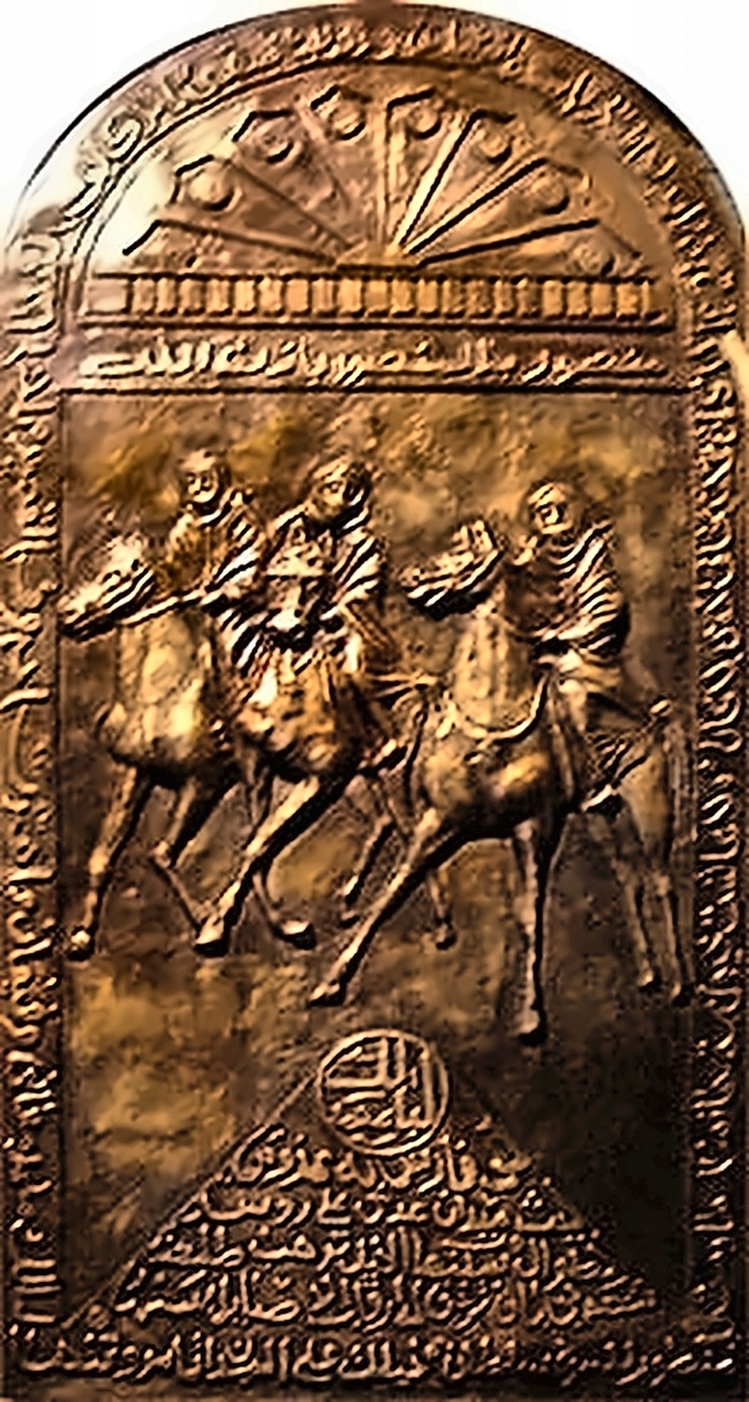 A cast bronze plaque of three horsemen at the gallop, framed above and below by bands of Arabic inscription.